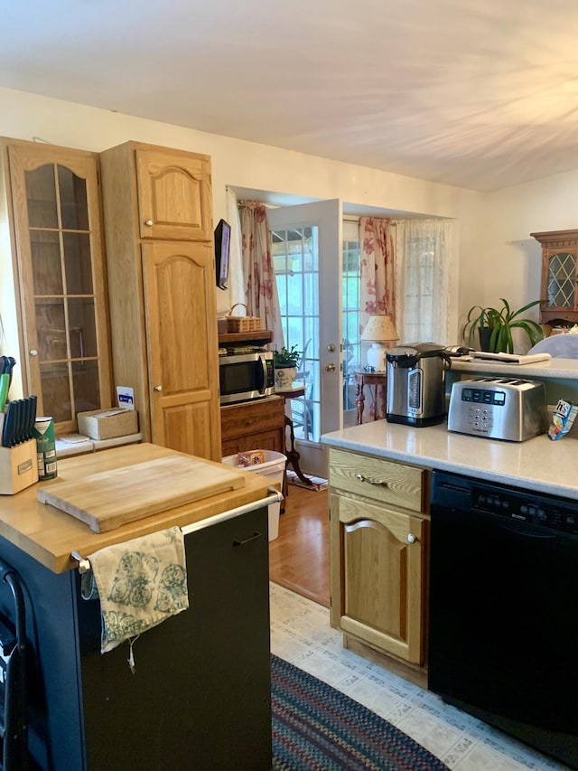 150 Leach Point Rd, Perry, ME 04667 - kitchen with dishwasher, stainless steel microwave, light wood-style floors, light brown cabinetry, and wooden counters