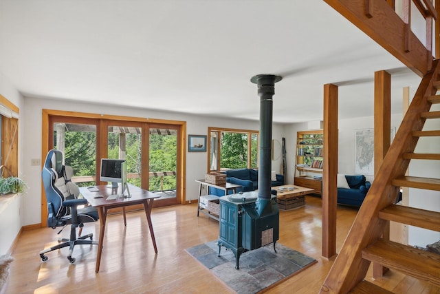 911 Orion Point Way, Harpswell, ME 04079 - office area featuring a wood stove and light wood-style flooring