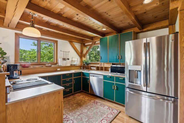 911 Orion Point Way, Harpswell, ME 04079 - kitchen featuring appliances with stainless steel finishes, a wood ceiling with exposed beams, healthy amount of natural light, light wood-style flooring, and green cabinets