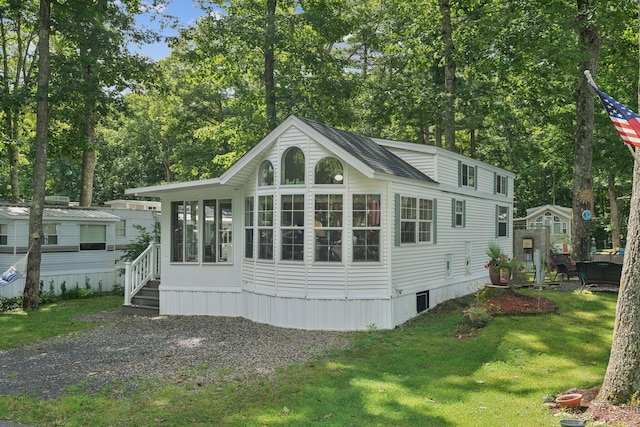 191 Tatnic Rd Unit 74, Wells, ME 04090 - back of house featuring a sunroom and a lawn