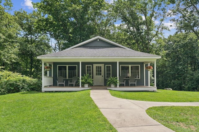 191 Tatnic Rd Unit 74, Wells, ME 04090 - bungalow-style home featuring covered porch, roof with shingles, and a front lawn