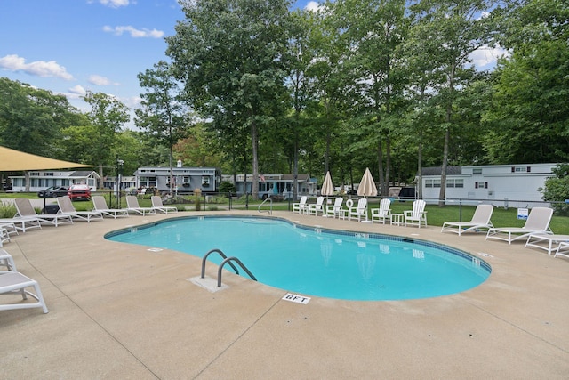 191 Tatnic Rd Unit 74, Wells, ME 04090 - community pool with view of wooded area and a patio