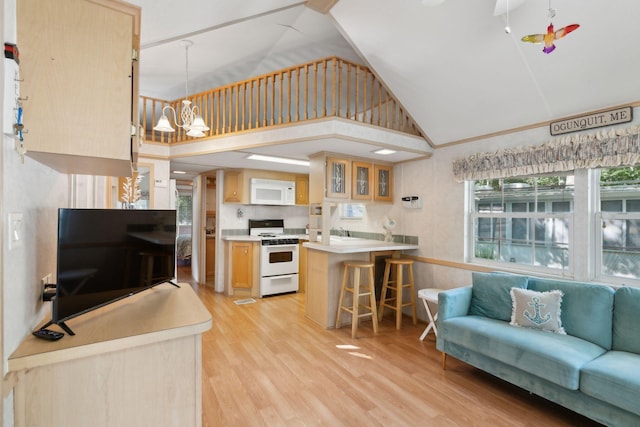 191 Tatnic Rd Unit 74, Wells, ME 04090 - kitchen with white appliances, open floor plan, light brown cabinetry, a kitchen bar, and light wood-style floors