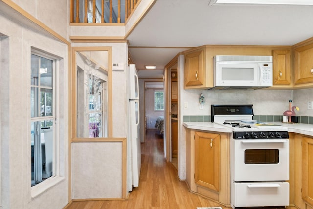 191 Tatnic Rd Unit 74, Wells, ME 04090 - kitchen with white appliances, light wood finished floors, plenty of natural light, and light countertops