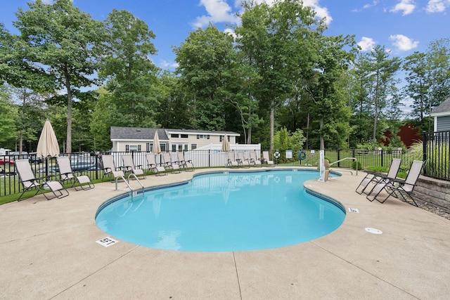 191 Tatnic Rd Unit 74, Wells, ME 04090 - community pool featuring a patio area and view of wooded area