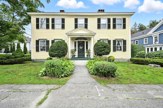 43 Green St, Augusta, ME 04330 - colonial home featuring a front lawn and a chimney