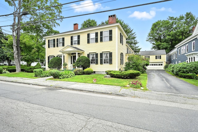 43 Green St, Augusta, ME 04330 - colonial house featuring a chimney, a front lawn, and a garage