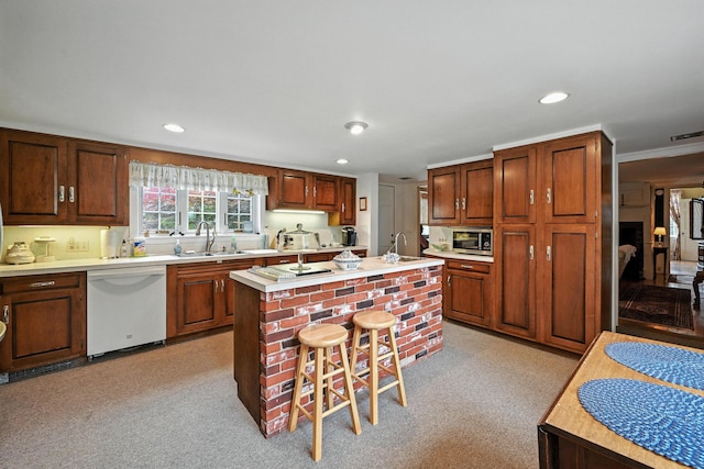 43 Green St, Augusta, ME 04330 - kitchen with white dishwasher, stainless steel microwave, light countertops, a center island with sink, and a breakfast bar
