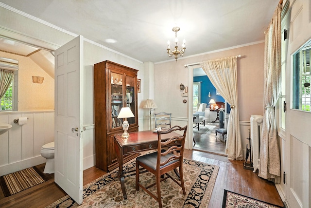 43 Green St, Augusta, ME 04330 - dining room featuring wood finished floors, healthy amount of natural light, wainscoting, a chandelier, and ornamental molding