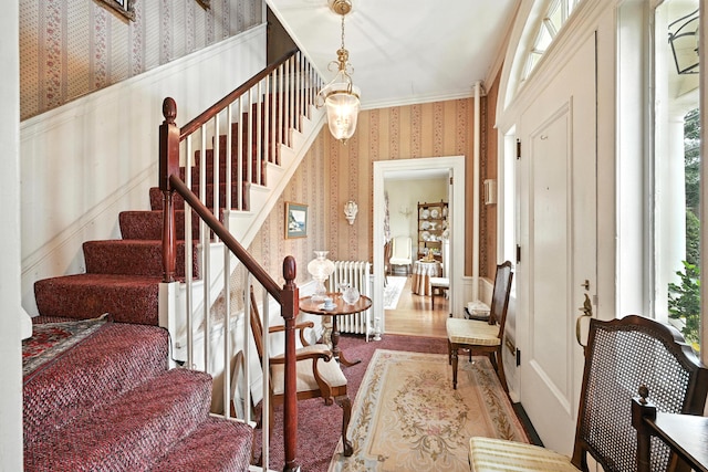 43 Green St, Augusta, ME 04330 - entryway featuring wallpapered walls, radiator, stairs, a wainscoted wall, and a decorative wall