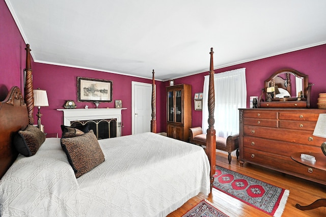 43 Green St, Augusta, ME 04330 - bedroom featuring wood finished floors, crown molding, and a fireplace