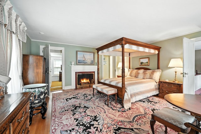43 Green St, Augusta, ME 04330 - bedroom featuring wood finished floors, ornamental molding, and a fireplace with flush hearth