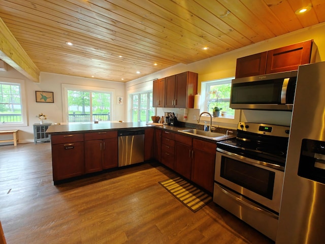 48 Sebasticook Ave, Newport, ME 04953 - kitchen with stainless steel appliances, wooden ceiling, dark countertops, a peninsula, and healthy amount of natural light