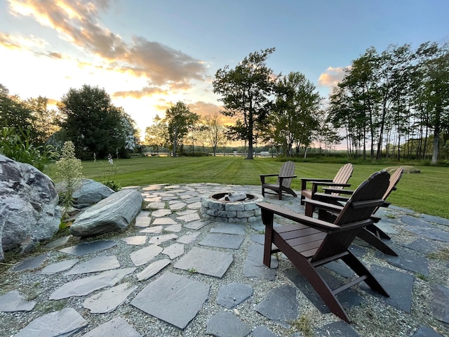 48 Sebasticook Ave, Newport, ME 04953 - patio terrace at dusk featuring a fire pit, a lawn, and a patio