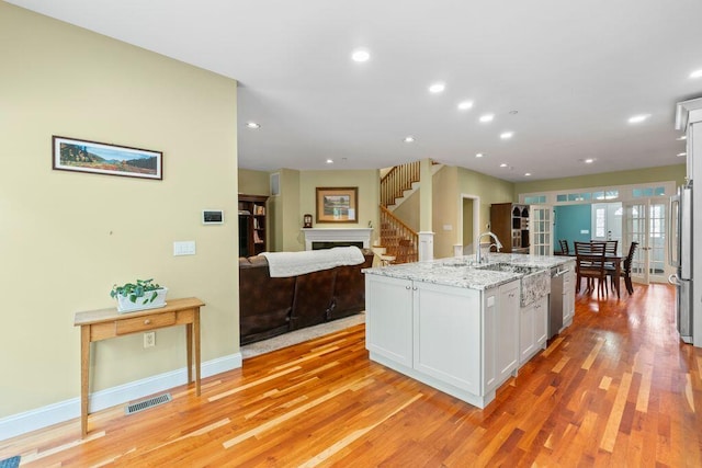 38 Harvest Hill Ln Unit 38, Auburn, ME 04210 - kitchen with white cabinetry, appliances with stainless steel finishes, light wood-type flooring, light stone countertops, and recessed lighting