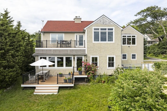 1 Grimes Ave, Boothbay, ME 04544 - rear view of property with a balcony, a chimney, a lawn, outdoor dining area, and a deck