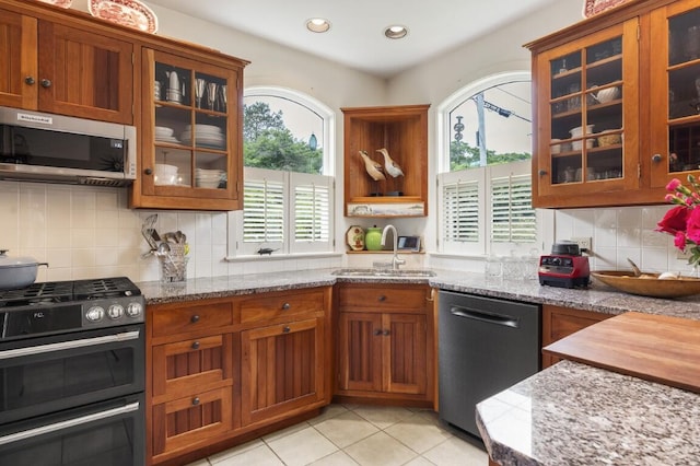 1 Grimes Ave, Boothbay, ME 04544 - kitchen featuring stainless steel appliances, healthy amount of natural light, brown cabinetry, light stone countertops, and recessed lighting