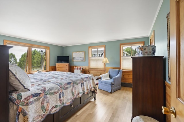 1 Grimes Ave, Boothbay, ME 04544 - bedroom with light wood-style floors, wainscoting, and ornamental molding