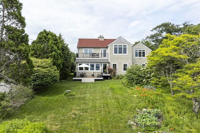1 Grimes Ave, Boothbay, ME 04544 - rear view of house with a balcony, a yard, a chimney, and a wooden deck
