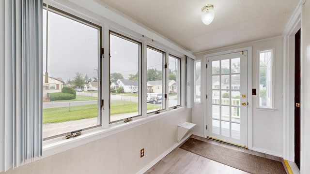 307 Russell St, Lewiston, ME 04240 - unfurnished sunroom with wood finished floors and baseboards