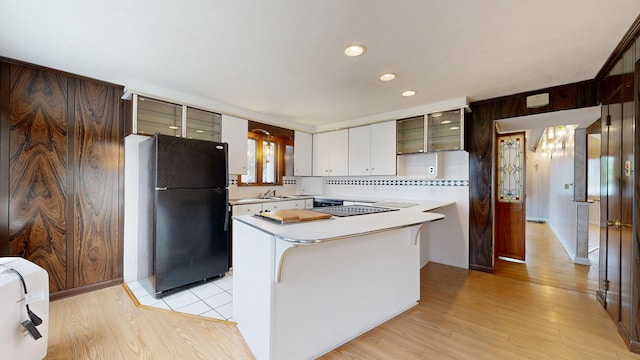 307 Russell St, Lewiston, ME 04240 - kitchen featuring freestanding refrigerator, light countertops, glass insert cabinets, light wood-style flooring, and recessed lighting