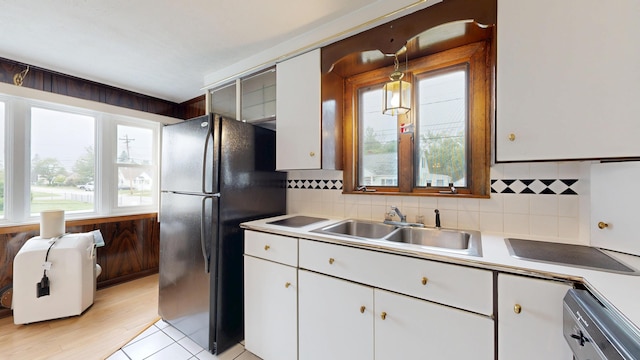 307 Russell St, Lewiston, ME 04240 - kitchen with freestanding refrigerator, white cabinetry, decorative backsplash, and light countertops