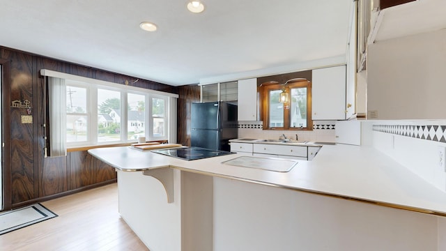 307 Russell St, Lewiston, ME 04240 - kitchen featuring a peninsula, light countertops, black appliances, light wood-type flooring, and recessed lighting