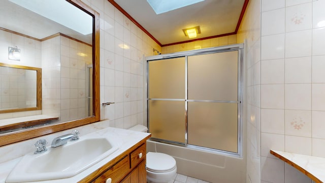 307 Russell St, Lewiston, ME 04240 - full bath featuring tile walls, crown molding, vanity, combined bath / shower with glass door, and a skylight