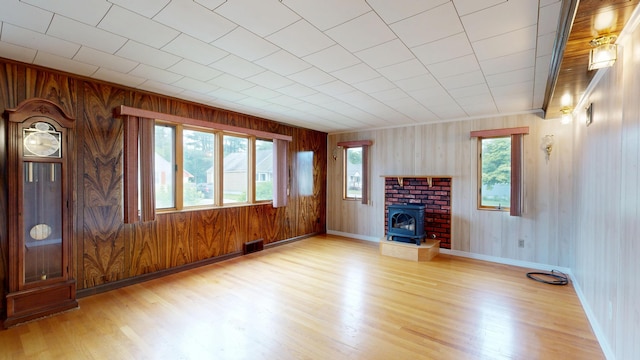 307 Russell St, Lewiston, ME 04240 - unfurnished living room featuring light wood-type flooring and wood walls
