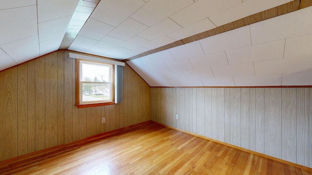 307 Russell St, Lewiston, ME 04240 - additional living space with wood-type flooring, vaulted ceiling, and wood walls