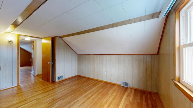 307 Russell St, Lewiston, ME 04240 - additional living space with light wood-style flooring, vaulted ceiling, and wood walls