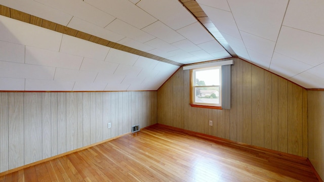 307 Russell St, Lewiston, ME 04240 - additional living space with hardwood / wood-style floors, wooden walls, and vaulted ceiling