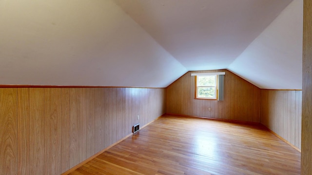 307 Russell St, Lewiston, ME 04240 - additional living space featuring light wood-type flooring, vaulted ceiling, and wood walls