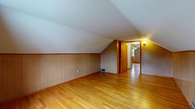 307 Russell St, Lewiston, ME 04240 - additional living space with light wood finished floors, lofted ceiling, and wood walls