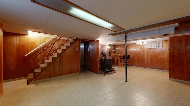 307 Russell St, Lewiston, ME 04240 - finished below grade area featuring tile patterned floors, wood walls, stairway, and a wood stove