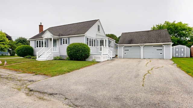 307 Russell St, Lewiston, ME 04240 - view of front facade featuring a shingled roof, a front lawn, a storage unit, and a chimney