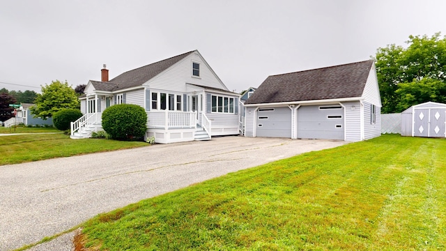 307 Russell St, Lewiston, ME 04240 - view of front of house with a garage, a shingled roof, a chimney, a front yard, and a storage unit