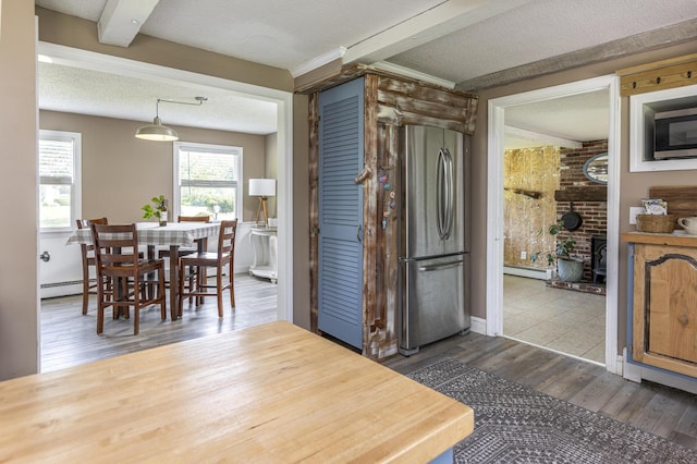 14 Bailey Ln, Brunswick, ME 04011 - kitchen with appliances with stainless steel finishes, dark wood-type flooring, a textured ceiling, beamed ceiling, and a baseboard radiator