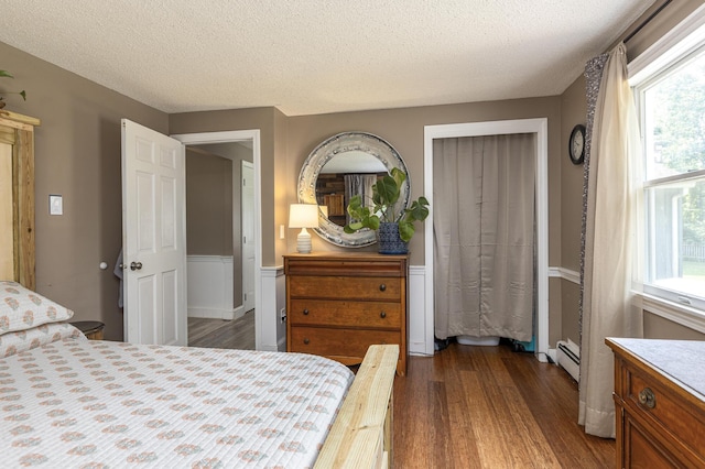 14 Bailey Ln, Brunswick, ME 04011 - bedroom featuring wood finished floors, a textured ceiling, and a baseboard radiator