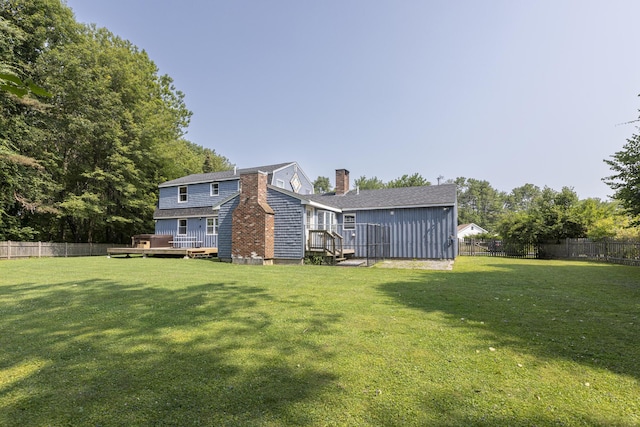 14 Bailey Ln, Brunswick, ME 04011 - back of house featuring a fenced backyard, a chimney, and a deck