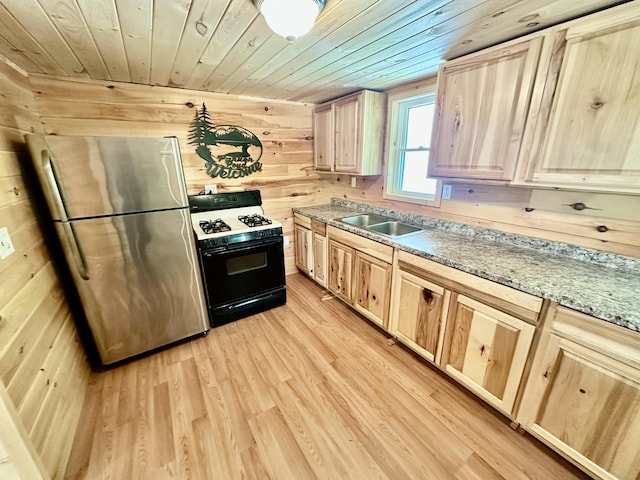 52 Quimby Ln, Fayette, ME 04349 - kitchen featuring gas range oven, freestanding refrigerator, light brown cabinetry, wood ceiling, and light wood finished floors