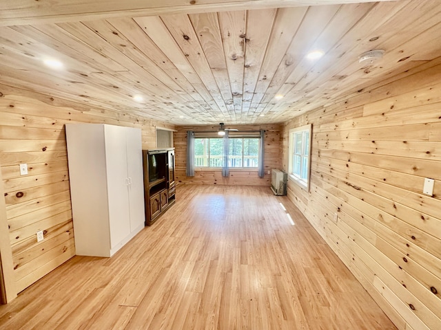 52 Quimby Ln, Fayette, ME 04349 - unfurnished living room featuring wood walls, light wood-style floors, wood ceiling, and an AC wall unit