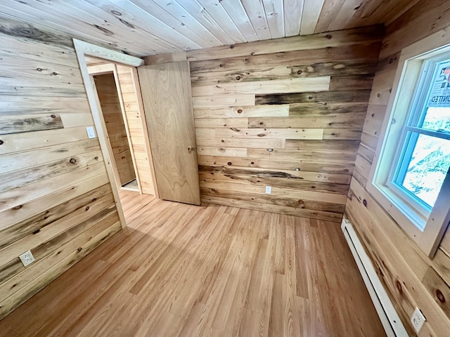 52 Quimby Ln, Fayette, ME 04349 - empty room with wood walls, a baseboard heating unit, wooden ceiling, and light wood finished floors