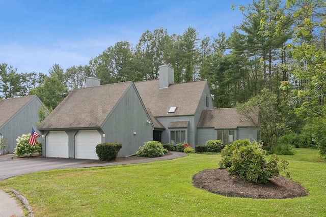 20 Wonderbrook Dr Unit 20, Kennebunk, ME 04043 - view of front of house with a chimney, a front yard, roof with shingles, asphalt driveway, and an attached garage