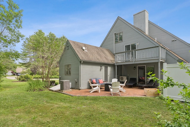 20 Wonderbrook Dr Unit 20, Kennebunk, ME 04043 - rear view of property with a balcony, a patio, a lawn, a chimney, and roof with shingles