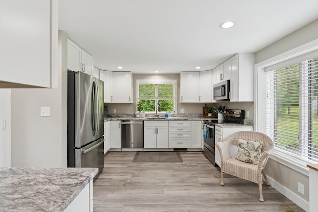 20 Wonderbrook Dr Unit 20, Kennebunk, ME 04043 - kitchen featuring stainless steel appliances, recessed lighting, white cabinets, light stone countertops, and light wood-style flooring