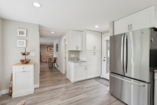 20 Wonderbrook Dr Unit 20, Kennebunk, ME 04043 - kitchen featuring freestanding refrigerator, light wood-style flooring, white cabinets, recessed lighting, and light stone countertops