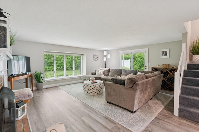 20 Wonderbrook Dr Unit 20, Kennebunk, ME 04043 - living area with a fireplace, wood finished floors, and stairway