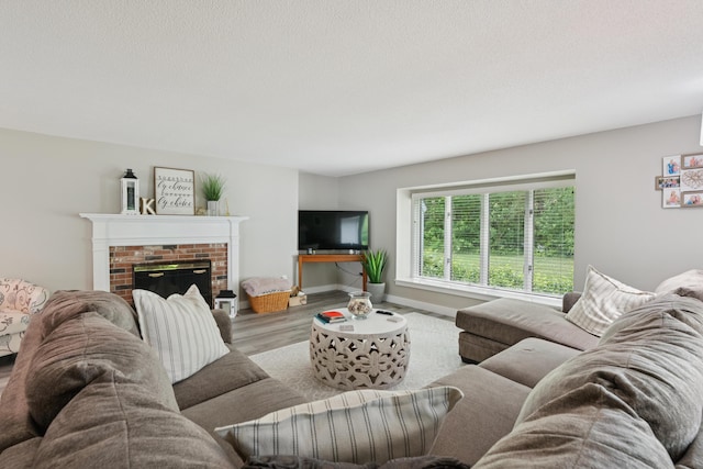 20 Wonderbrook Dr Unit 20, Kennebunk, ME 04043 - living room with wood finished floors and a brick fireplace