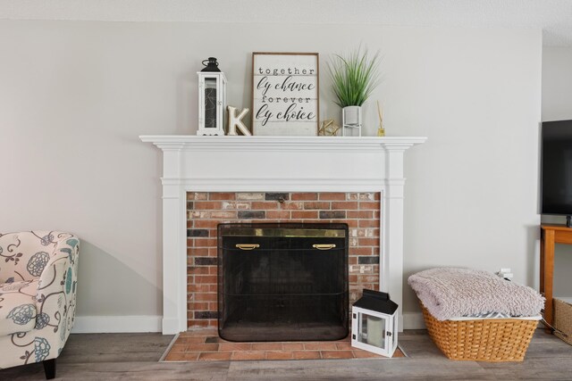20 Wonderbrook Dr Unit 20, Kennebunk, ME 04043 - detailed view of a brick fireplace and wood finished floors